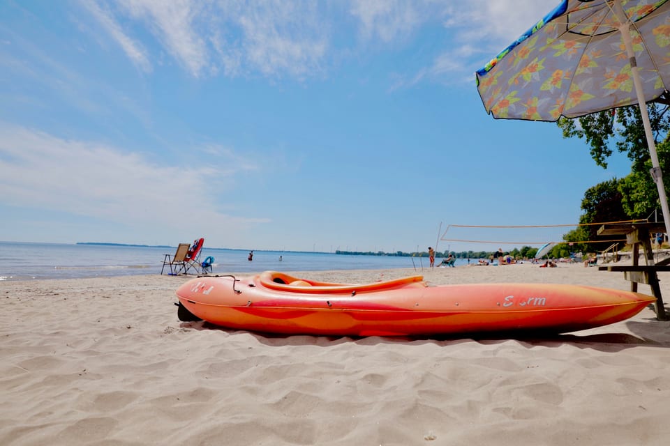 Kayaks pulled up on the beach at The Long Beach Resort