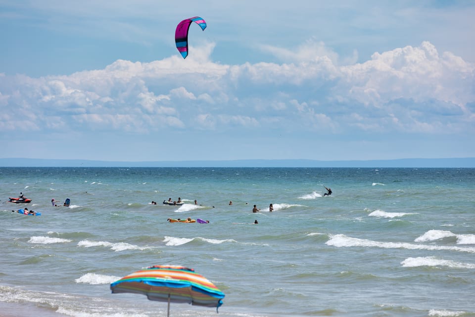 A kite surfer riding the waves off Long Beach