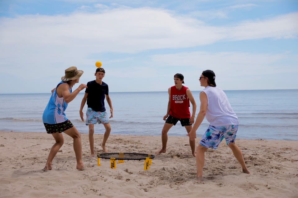 A game of spikeball on the beach