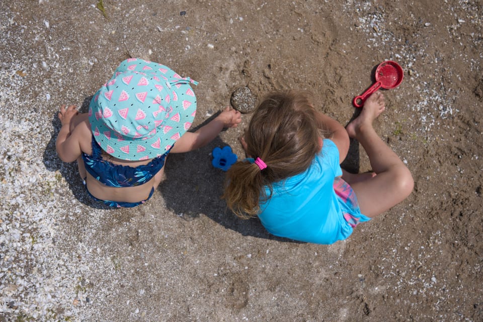 Children digging in the sand at Long Beach
